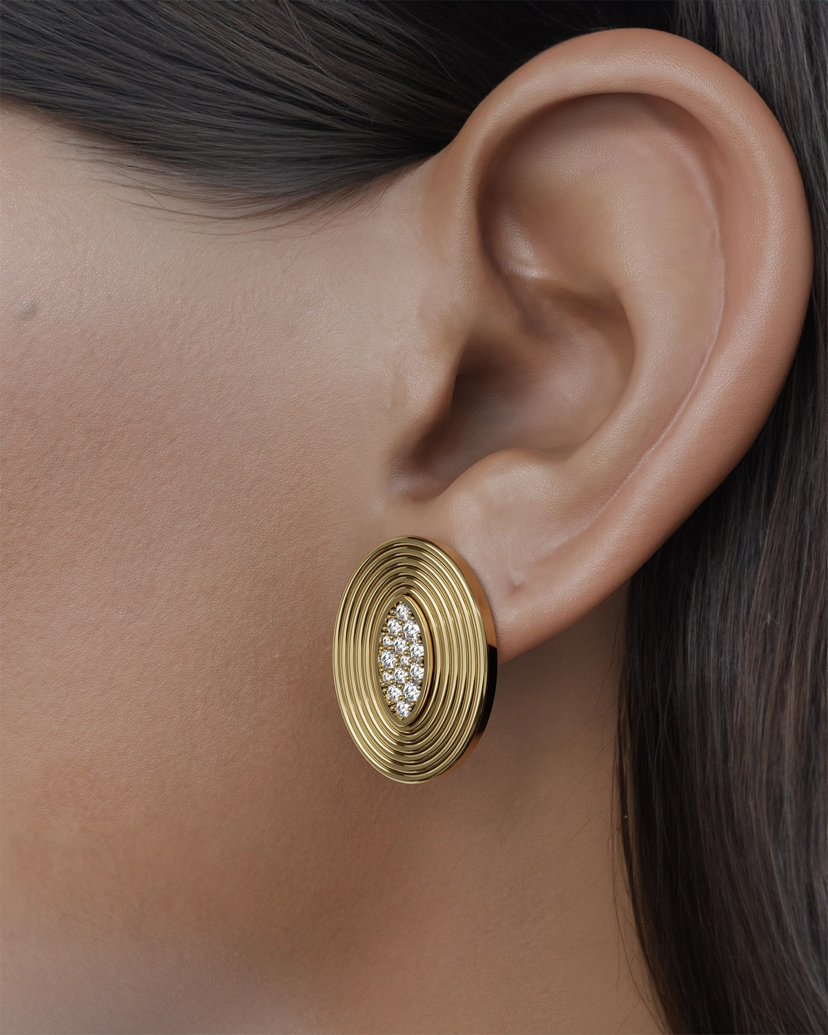 These stunning oval earrings are designed to make a statement, featuring a dazzling array of diamonds artfully set in the center. Their unique shape and brilliant sparkle create an eye-catching focal point that glimmers with every movement. Perfect for elevating any outfit, these earrings effortlessly combine elegance and sophistication, ensuring that the wearer turns heads and captures attention wherever they go. Whether for a special occasion or adding a touch of luxury to everyday wear, these earrings are the perfect accessory to express your personal style.