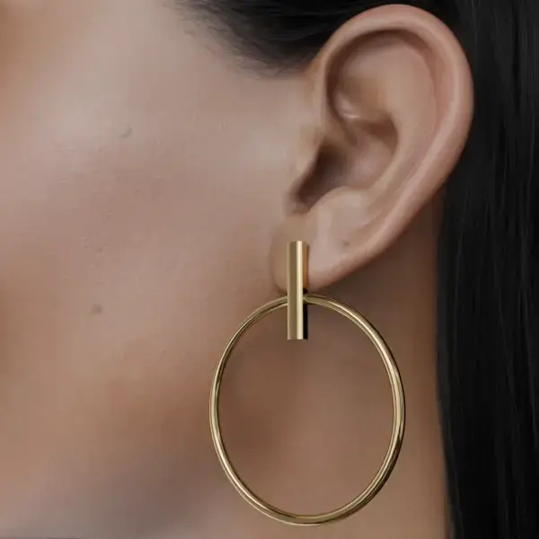 This unique earring features a beautifully crafted round piece delicately suspended from a slender stick, creating an eye-catching and contemporary aesthetic. The interplay between the sleek stick and the circular charm adds a modern twist to classic elegance, making it a versatile accessory for any outfit. Whether dressed up for a night out or paired with casual attire, this earring effortlessly elevates your style, showcasing a harmonious blend of sophistication and creativity.