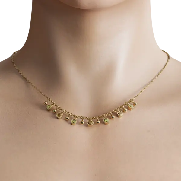 "Elevate your style with this stunning necklace, featuring small diamond slots that add a touch of luxury to any outfit. The diamonds are expertly set into the metalwork, creating a beautiful pattern that shimmers and shines."