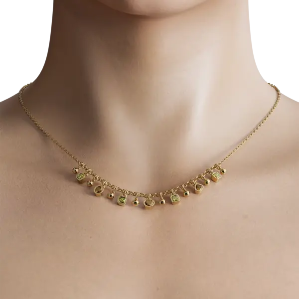 Adorning the chain are a series of intricately designed charms, each meticulously crafted to capture light and attention. The charms, embellished with brilliant-cut diamonds, add a touch of sparkle and sophistication, making this necklace a versatile accessory for both everyday wear and special occasions.