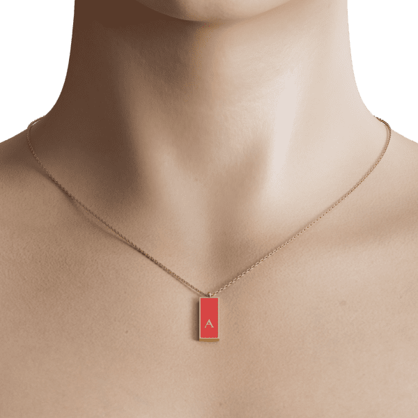 At the heart of the design lies a beautifully enameled initial charm, available in a variety of vibrant colors to suit your personal style. The smooth enamel surface catches the light beautifully, adding a pop of color against the shimmering gold backdrop. Whether you choose to represent your own initial or that of a loved one, this necklace is a meaningful addition to your wardrobe.