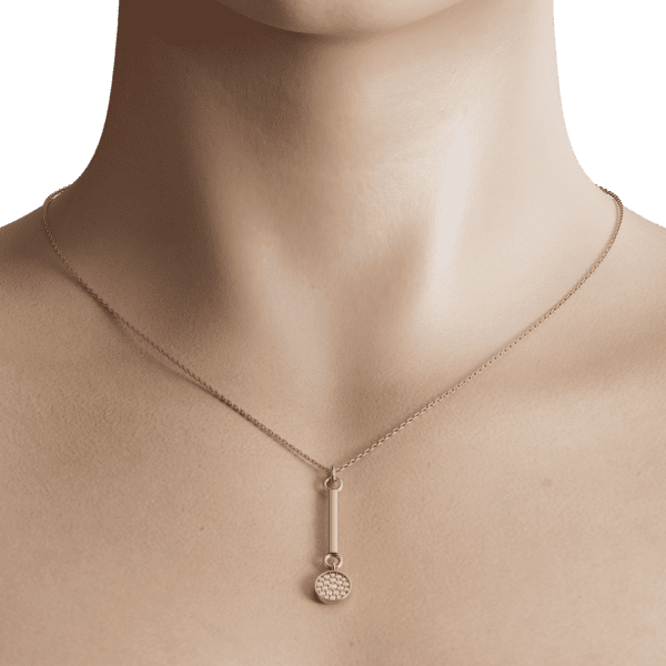 The gold rod chain, with its slender and elegant design, adds a touch of sophistication and refinement to the overall look. The subtle texture of the gold provides a beautiful contrast to the smoothness of the pendant, creating a harmonious balance of shapes and textures.