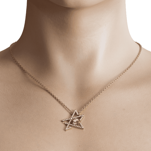 The pendant is elegantly suspended from a fine chain, allowing it to drape gracefully against the skin, making it a perfect accessory for both casual and formal occasions. Its unique design reflects the captivating theme of transformation and renewal, as the shattered star represents the beauty found in imperfection.