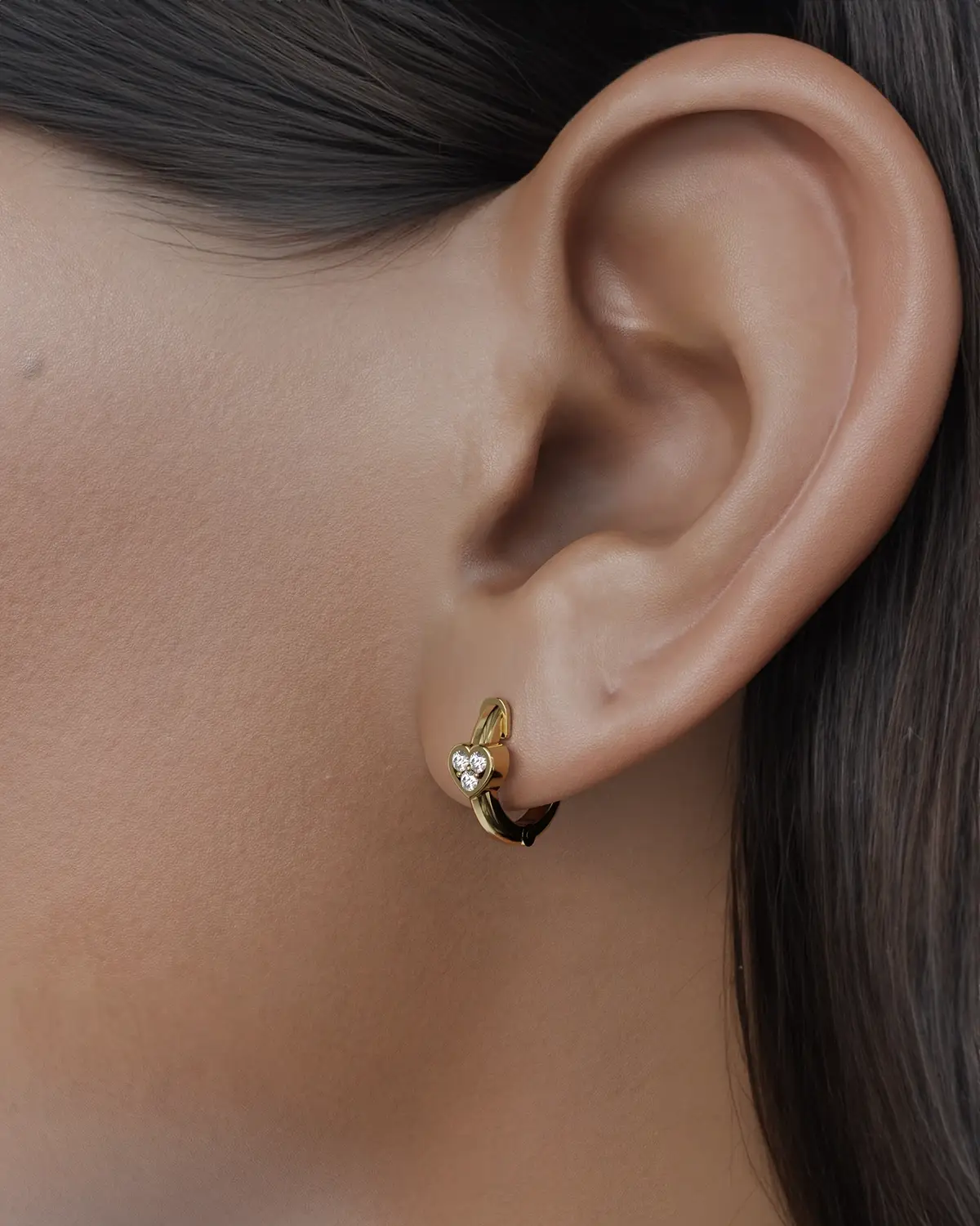 These elegant hoop earrings are a striking combination of contemporary design and cultural heritage, inspired by the iconic Cintemani motif. Each earring features a different slot, allowing for a stunning arrangement of sparkling diamonds that beautifully resemble the traditional Cintemani pattern. Crafted with meticulous attention to detail, these earrings offer a unique way to celebrate history and art, making them the perfect statement piece for any occasion. These hoop earrings are sure to be a valuable addition to your jewelry collection.